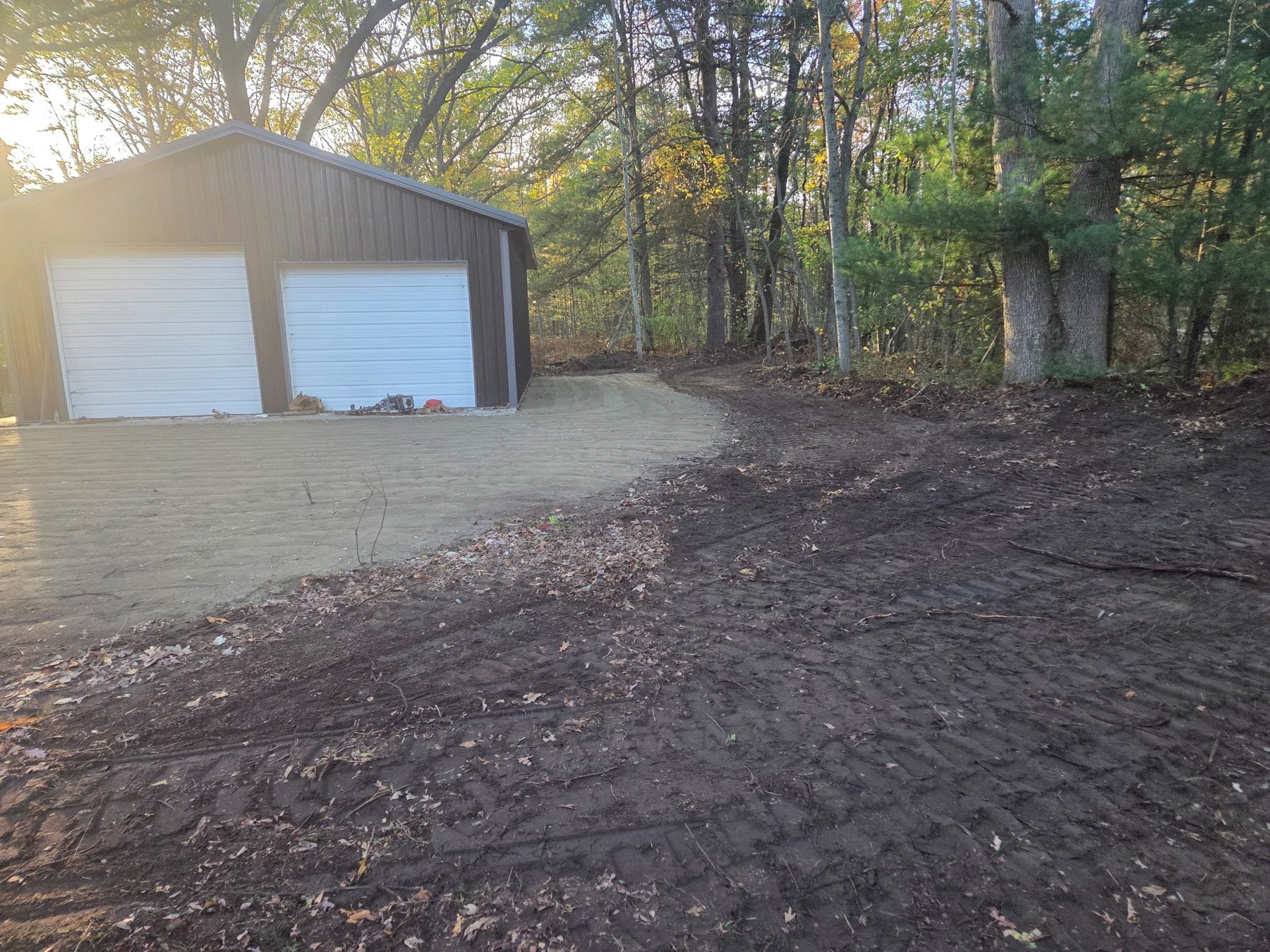 Finished parking pad and cleared area alongside Fruitport garage